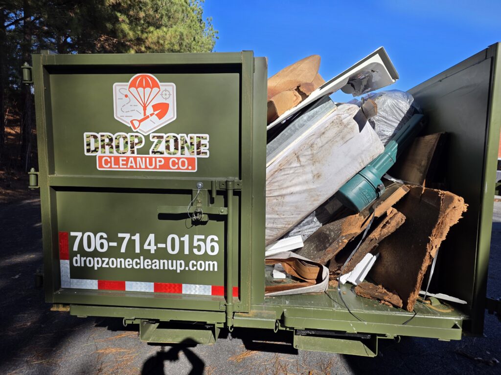 Drop Zone Cleanup dump trailer loaded with junk removal debris in Northeast Georgia