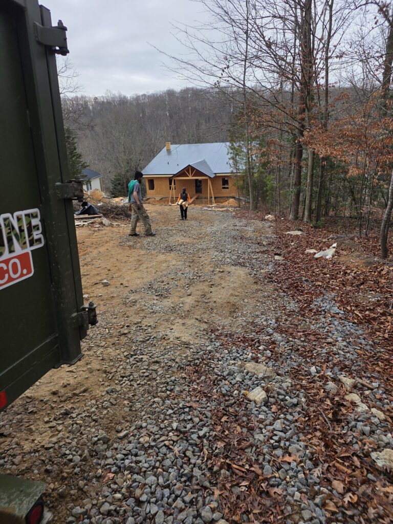 Drop Zone Cleanup Co. crew performing construction debris cleanup at a residential build site in Northeast Georgia with driveway access and jobsite labor support.